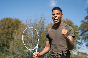 Smiling man with tennis racket