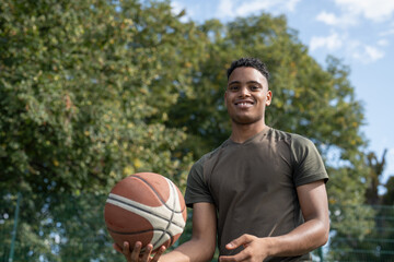 Smiling man playing basketball