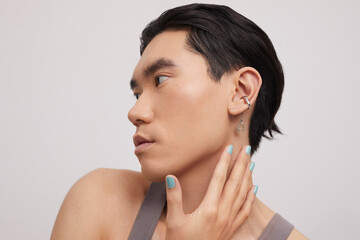Studio portrait of handsome man with ear piercing