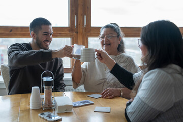 Three-generation family drinking tea at home
