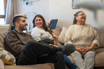 Smiling three-generation family watching TV