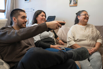 Smiling three-generation family watching TV