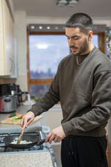 Young man preparing food at home