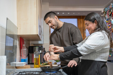 Mother and son cooking at home
