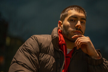 Portrait of young man outdoors at night