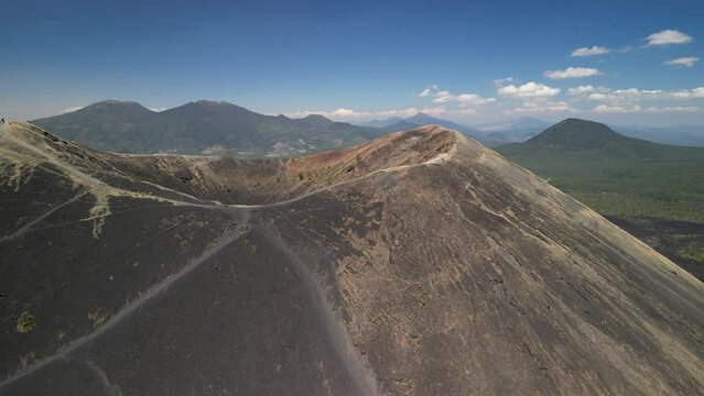 Drone footage of the Paricutin cinder cone volcano on a sunny day in the state of Michoacan, Mexico