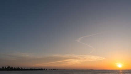 Sunset sky clouds over sea in the evening with Orange sunlight Golden hour, Landscape horizon sea sky, Dusk sky background 