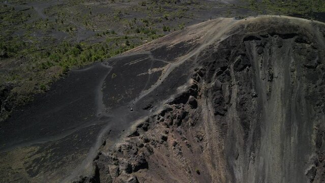 Ascending aerial view of people riding horses on a trail on Paricutin volcano in Michoacan, Mexico