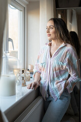 Woman standing and looking out window