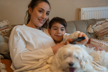 Mother and son (6-7) on sofa with dog