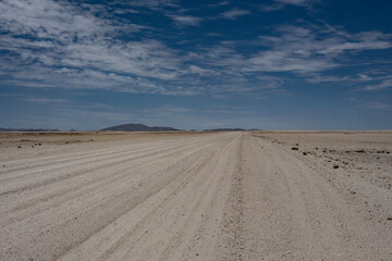 Fototapeta na wymiar magical beauty yellow mountains and a desert plain against the sky in the Namibian desert