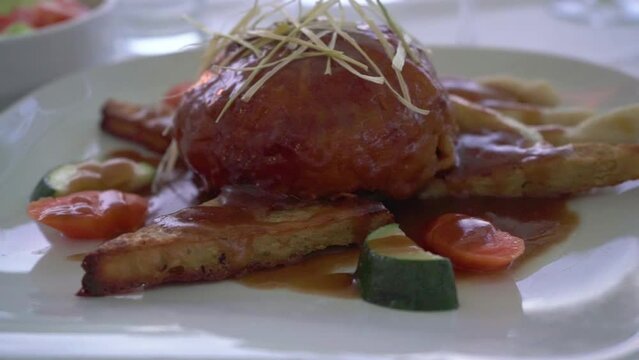 Croatian gastronomy meat and corn bread with brown sause and vegetables in an expensive restaurant terasse