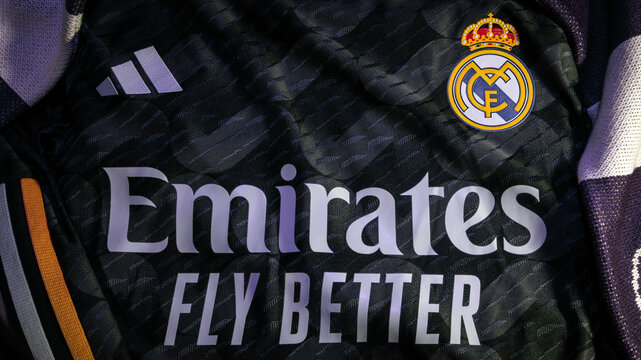 Madrid, Spain - February 9 2024 : Close up detail of Real Madrid football club icon attached to away soccer jersey with Adidas logo and fly emirates shirt sponsor. Horizontal landscape format