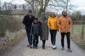 Three generation family walking together in rural area