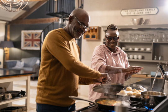 Senior couple preparing food in kitchen