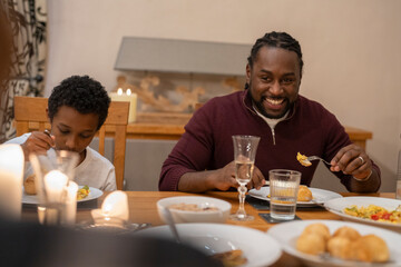 Father and son eating dinner together at home