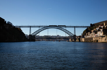 View of the Luis I Bridge, Muralha Fernandina and Gustavo Eiffel Avenue in O Porto on a sunny day with blue sky