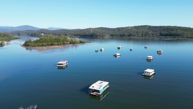 Aerial of many moors boats on the Clyde River with fresh in the background on a sunny day