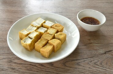 deep fried tofu dipping with sweet crushed bean sauce on plate