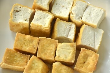 deep fried tofu dipping with sweet crushed bean sauce on plate