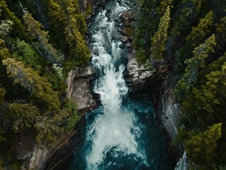 Naklejka na ściany i meble Top-down view of a waterfall cascading down into a pool below