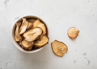 Top view of bowl with dried pear slices on light background.Macro.