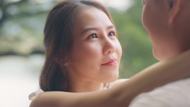 Young adult asia people happy lover flirt at outdoor nature falling in love desire kiss hug beloved care trust. Sweet comfort asian lovers tender face to face man woman smile relax warm time date day.