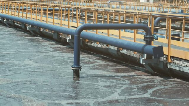 Process of purification effluent water flowing in outdoor channels at wastewater treatment plant facility.