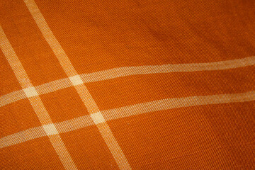 A beautiful sharp orange color Kain Pelikat or Kain Sarong with stripe forming a square shape. A traditional fabrics from Malaysia.
