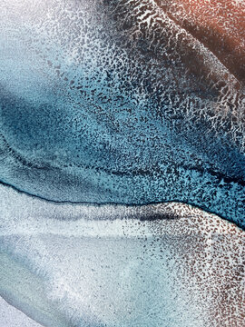Abstract fluid art in green and turquoise tones. Hand-made with alcohol ink. Features organic flowing shapes. No real property or natural materials depicted.