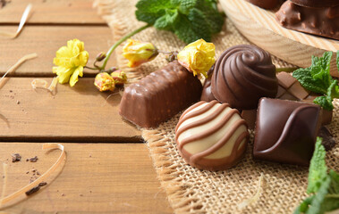 Organically farmed chocolates on burlap cloth on wooden table