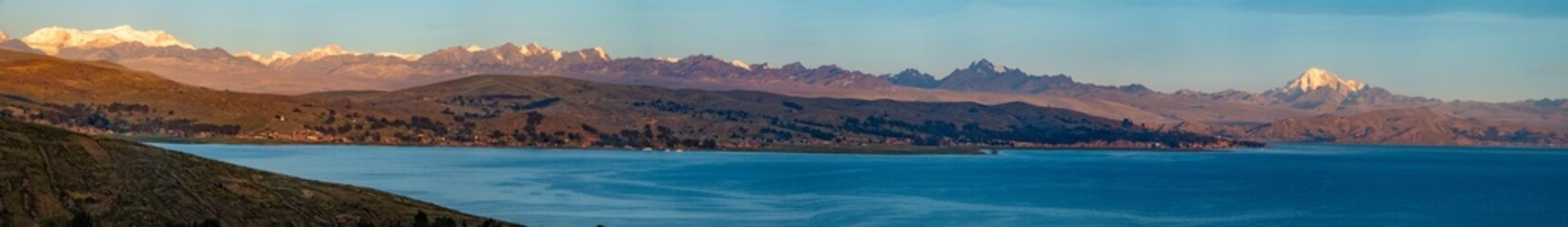 Panoramic view of the Cordillera Real mountains from the shores of the Titicaca Lake, Bolivia. The...