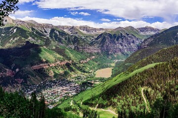 Picturesque view of the vibrant town of Telluride nestled in a valley surrounded by rolling hills.