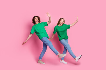 Full body length photo of youth brother and sister dancers boogie woogie enjoy dynamic music moves isolated on pink color background