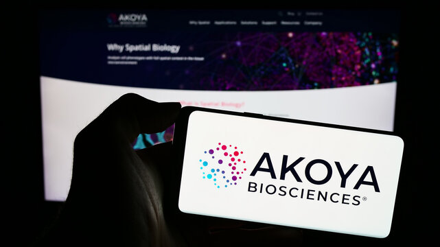 Stuttgart, Germany - 12-31-2023: Person holding mobile phone with logo of American biotechnology company Akoya Biosciences Inc. in front of web page. Focus on phone display.