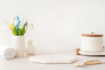 Marble white podium for cosmetics products display in bathroom with hygiene stuff and decor placed around