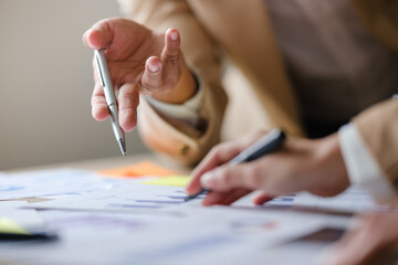 Close up shot business people team meeting in conference room in company. Businessman pointing pen...