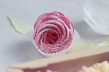 Close-up view of handmade black currant marshmallow (zephyr). Violet zefir on the grey background. Traditional Russian dessert. Romantic idea for present. Business concept