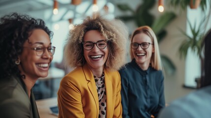 Diverse team celebrating success in a creative office space, all wearing professional attire, sharing joyful laughter. 