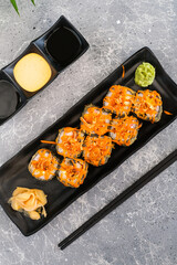 Baked rolls with cheese served with wasabi, pickled ginger, soy sauce and mayonnaise