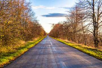 Beautiful empty asphalt road in countryside on colored background