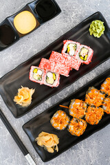 Set of Rolls with cheese, shrimp, avocado and cucumber, covered with red caviar and baked roll with cheese