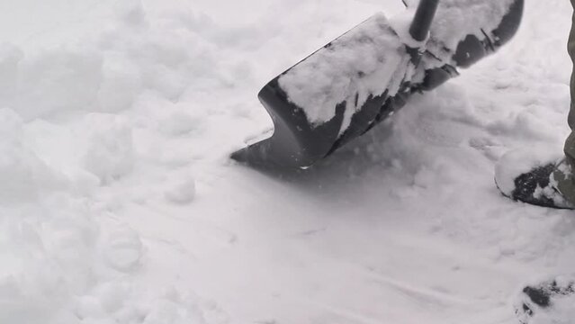 Shoveling snow from house deck