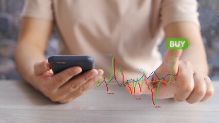 Business growth, progress or success concept.planning and strategy, Stock market,  Hand of Businessman or trader touching showing a growing virtual hologram stock on smartphone, invest in trading.