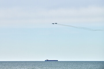 Two Russian military fighter planes armed with missiles fighter jets flying over sea, airborne...