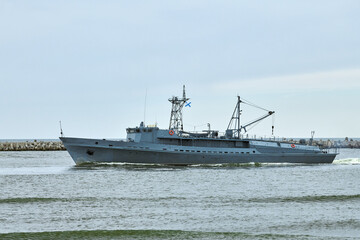 Russian warship armed with armament sails into sea toward military target to attack and destroy enemy, military ship performing strategic maneuver, Russian sea power deployment for tactical advantage