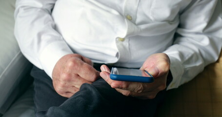 Older man using cellphone at home senior elder man touching smartphone screen