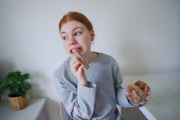 girl eating swedish candy at home