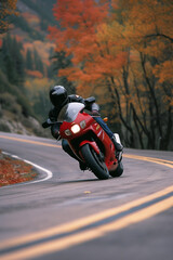 A man is riding a red motorcycle in an inland area that has good road quality.