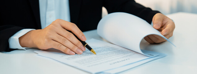 Business executive signing contract agreement document on the bale with the help from company...